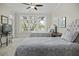 Cozy bedroom featuring two twin beds, ceiling fan, and natural lighting at 108 Fairbanks Oak Aly # 201, Charleston, SC 29492
