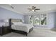 Light filled bedroom featuring a ceiling fan, tufted headboard and large windows at 108 Fairbanks Oak Aly # 201, Charleston, SC 29492