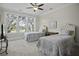 Bright bedroom with two beds, ceiling fan, and abundant natural light at 108 Fairbanks Oak Aly # 201, Charleston, SC 29492
