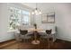 Cozy breakfast nook with natural light, booth seating, and a round wood table at 108 Fairbanks Oak Aly # 201, Charleston, SC 29492