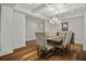Traditional dining room features hardwood floors, a modern chandelier, and wainscotting at 108 Fairbanks Oak Aly # 201, Charleston, SC 29492