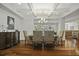 The dining room features a coffered ceiling, hardwood floors, and flows into other living spaces at 108 Fairbanks Oak Aly # 201, Charleston, SC 29492