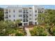Exterior view of a multi-story condo building surrounded by lush landscaping at 108 Fairbanks Oak Aly # 201, Charleston, SC 29492