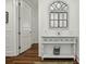 Charming hallway with decorative table, arched mirror, and hardwood floors at 108 Fairbanks Oak Aly # 201, Charleston, SC 29492
