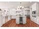 Bright kitchen with white cabinets, modern appliances, and a central island with a wine fridge at 108 Fairbanks Oak Aly # 201, Charleston, SC 29492