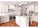 Elegant kitchen with white cabinets, stainless steel appliances, and a marble backsplash creating a modern design at 108 Fairbanks Oak Aly # 201, Charleston, SC 29492
