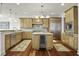 Spacious kitchen featuring wood cabinets, stainless steel appliances, and a central island with a beverage cooler at 108 Fairbanks Oak Aly # 201, Charleston, SC 29492