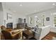 Bright living room features a fireplace, a large TV, and access to the outdoors through French doors at 108 Fairbanks Oak Aly # 201, Charleston, SC 29492