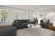 Bright living room with a dark gray couch, round marble coffee table, and open floor plan at 108 Fairbanks Oak Aly # 201, Charleston, SC 29492