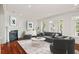 Cozy living room with modern decor, a fireplace, and large windows that provide natural light and views at 108 Fairbanks Oak Aly # 201, Charleston, SC 29492