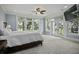 Light-filled main bedroom with neutral carpet, many windows, and private balcony access at 108 Fairbanks Oak Aly # 201, Charleston, SC 29492