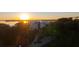 Breathtaking sunrise aerial view of waterfront property and lush landscaping at 108 Fairbanks Oak Aly # 302, Daniel Island, SC 29492