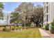 Well-maintained backyard with mature trees, manicured lawn, and elegant landscaping at 108 Fairbanks Oak Aly # 302, Daniel Island, SC 29492