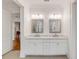Bright bathroom featuring a double vanity with marble counters and framed mirrors at 108 Fairbanks Oak Aly # 302, Daniel Island, SC 29492