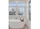 Bright bathroom with soaking tub by the window and glass enclosed shower; a spa-like experience at 108 Fairbanks Oak Aly # 302, Daniel Island, SC 29492