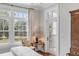 Cozy bedroom featuring a large window, light walls, and hardwood flooring at 108 Fairbanks Oak Aly # 302, Daniel Island, SC 29492