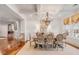 Elegant dining room featuring a coffered ceiling, wood floors, chandelier, and neutral tones, ideal for entertaining guests at 108 Fairbanks Oak Aly # 302, Daniel Island, SC 29492