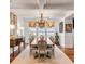 Elegant dining room with hardwood floors, chandelier, and large windows at 108 Fairbanks Oak Aly # 302, Daniel Island, SC 29492