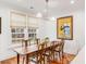 Well-lit dining room with hardwood floors, area rug, and view of the backyard at 108 Fairbanks Oak Aly # 302, Daniel Island, SC 29492