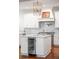 Kitchen island with wine cooler, marble countertops, stainless steel appliances, and hardwood floors at 108 Fairbanks Oak Aly # 302, Daniel Island, SC 29492