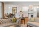 Open concept living area with view into dining room and kitchen; hardwood floors throughout at 108 Fairbanks Oak Aly # 302, Daniel Island, SC 29492