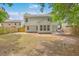 Backyard view with a dining area near the house surrounded by green trees and grass at 110 Moon Shadow Ln, Summerville, SC 29485