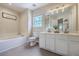 Bright bathroom featuring a soaking tub, and double sink vanity at 110 Moon Shadow Ln, Summerville, SC 29485