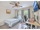 Cozy bedroom featuring a single bed, a ceiling fan with lights, and a modern desk and workspace at 110 Moon Shadow Ln, Summerville, SC 29485