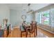 Charming dining room featuring modern light fixture, round mirror, and hardwood flooring at 110 Moon Shadow Ln, Summerville, SC 29485