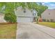 Inviting home with light gray siding, two-car garage, lush lawn, and tasteful landscaping at 110 Moon Shadow Ln, Summerville, SC 29485