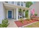 Welcoming front porch features cozy seating, tasteful decor, and beautiful landscaping at 110 Moon Shadow Ln, Summerville, SC 29485