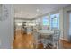 Bright kitchen with white cabinets, stainless appliances, island, and breakfast table at 110 Moon Shadow Ln, Summerville, SC 29485
