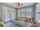 Bright sunroom with natural light and a ceiling fan at 110 Moon Shadow Ln, Summerville, SC 29485