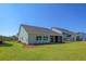 This home has a well-manicured backyard with a lush green lawn and a screened patio at 114 Headwater Dr, Summerville, SC 29486