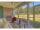 This screened patio features a wood-burning fireplace with a lush green lawn beyond the screen at 114 Headwater Dr, Summerville, SC 29486