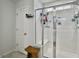 Bright white bathroom with glass enclosed shower, wooden stool, and storage at 115 Daniels Creek Cir, Goose Creek, SC 29445