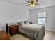 Bright bedroom with ceiling fan, window, and side table with lamp at 115 Daniels Creek Cir, Goose Creek, SC 29445
