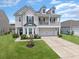 Inviting home with manicured lawn, and charming architectural details at 115 Daniels Creek Cir, Goose Creek, SC 29445