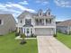 Charming two-story home with a welcoming front porch and well-manicured lawn at 115 Daniels Creek Cir, Goose Creek, SC 29445
