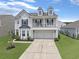 Beautiful two-story home with a spacious driveway and inviting front yard landscaping at 115 Daniels Creek Cir, Goose Creek, SC 29445