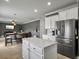 Open-concept kitchen with an island, stainless steel refrigerator, and modern lighting at 115 Daniels Creek Cir, Goose Creek, SC 29445