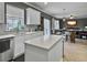 Bright kitchen featuring quartz countertops, island, and views into a cozy living space at 115 Daniels Creek Cir, Goose Creek, SC 29445