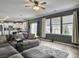 Open concept living room with hardwood floors, lots of windows, and view into the kitchen at 115 Daniels Creek Cir, Goose Creek, SC 29445