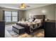 Cozy main bedroom with large bed, area rug, ceiling fan, and natural light at 115 Daniels Creek Cir, Goose Creek, SC 29445