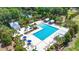 Aerial view of a large, resort-style pool surrounded by lush landscaping and lounge chairs at 120 Loon Dr, Summerville, SC 29483
