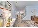 Inviting hallway with hardwood floors that leads to a modern kitchen and staircase at 120 Loon Dr, Summerville, SC 29483