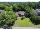 An aerial view showcases a well-manicured lawn, mature trees, and a glimpse of the home's roof at 1218 Chersonese Round, Mount Pleasant, SC 29464