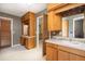 The ensuite bathroom featuring a vanity with tiled countertop and decorative wallpaper at 1218 Chersonese Round, Mount Pleasant, SC 29464