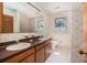 Bathroom featuring a double vanity, toilet and window with natural light at 1218 Chersonese Round, Mount Pleasant, SC 29464