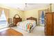 Bright bedroom with wooden furniture and views of the yard through the large windows at 1218 Chersonese Round, Mount Pleasant, SC 29464